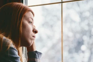 Woman looking out of window in winter
